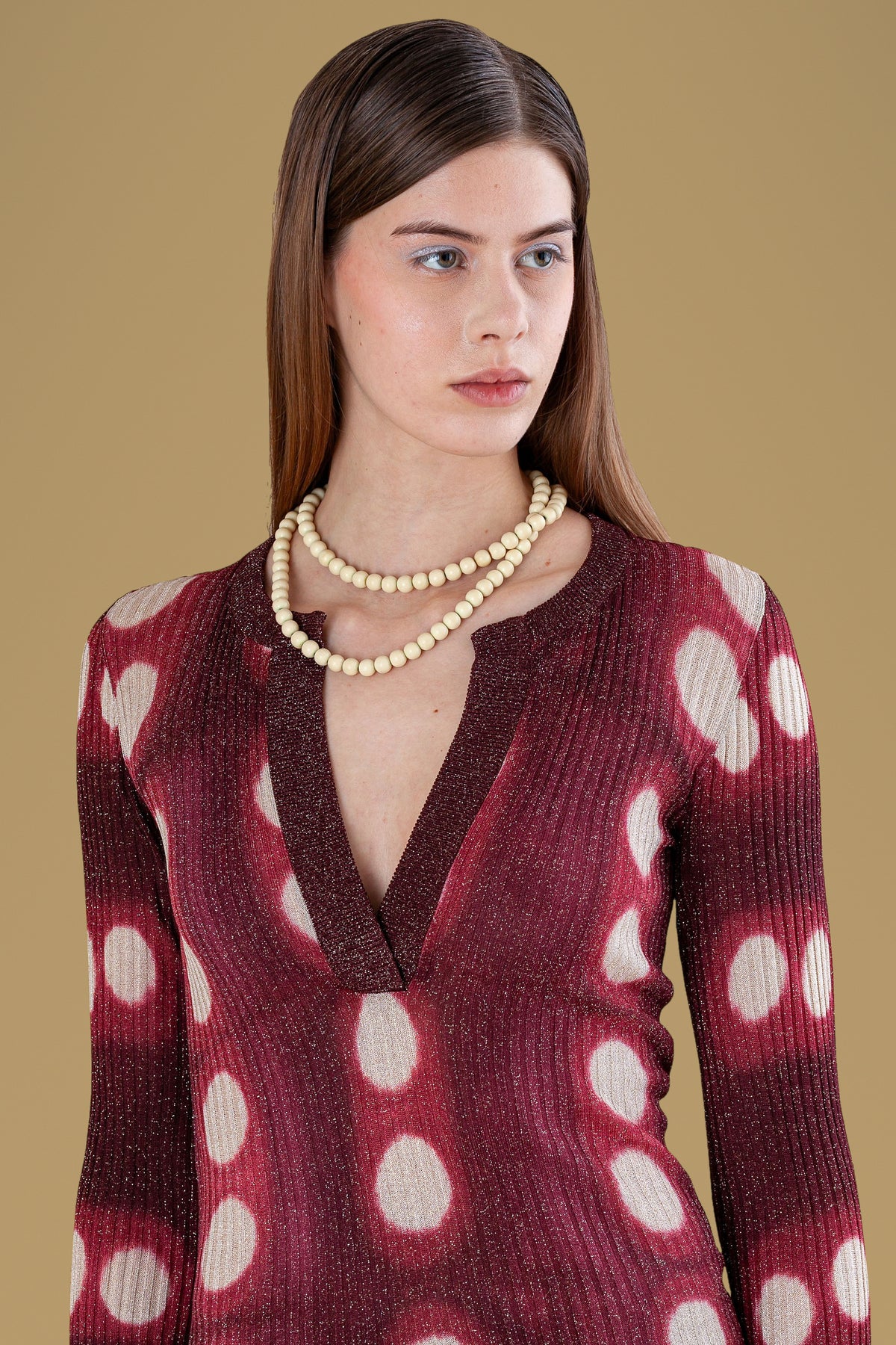 Close-up of ribbed knit and tie-dyed circles on burgundy henley