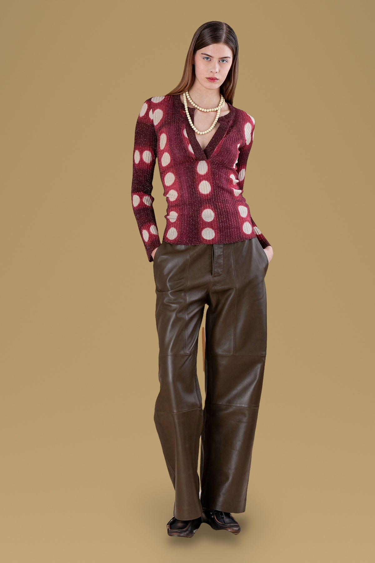 Burgundy tie-dye circles ribbed henley, front view, worn with leather trousers