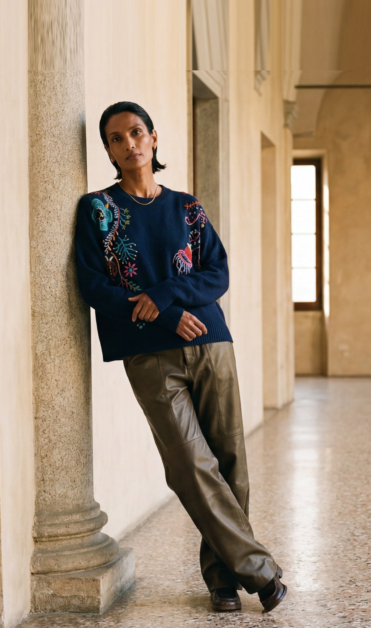 Happy Sheep FW26, hand-embroidered relaxed crew in navy. AI-generated campaign image