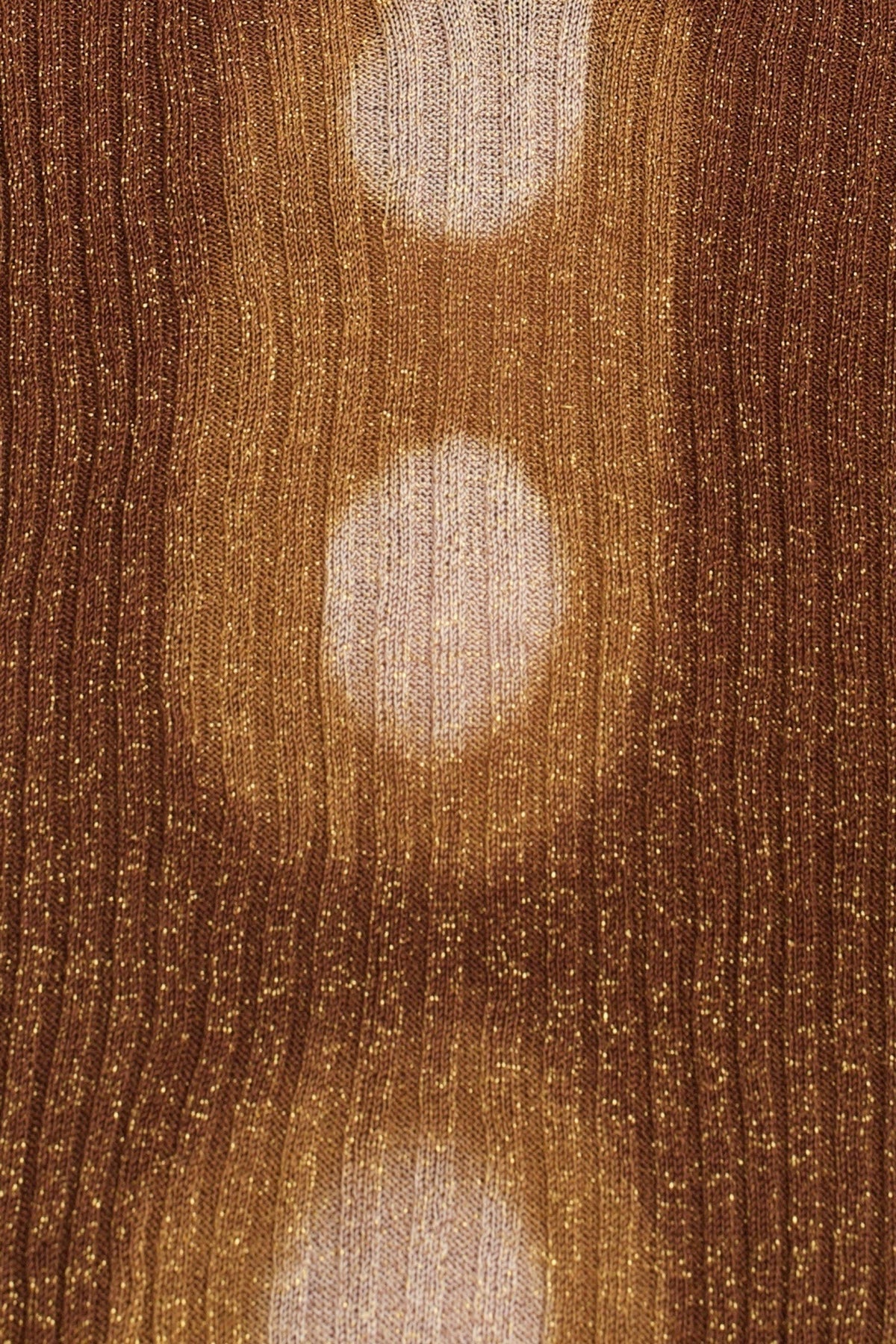 Close-up of the hand tie-dyed pink circles on the brown ribbed knit