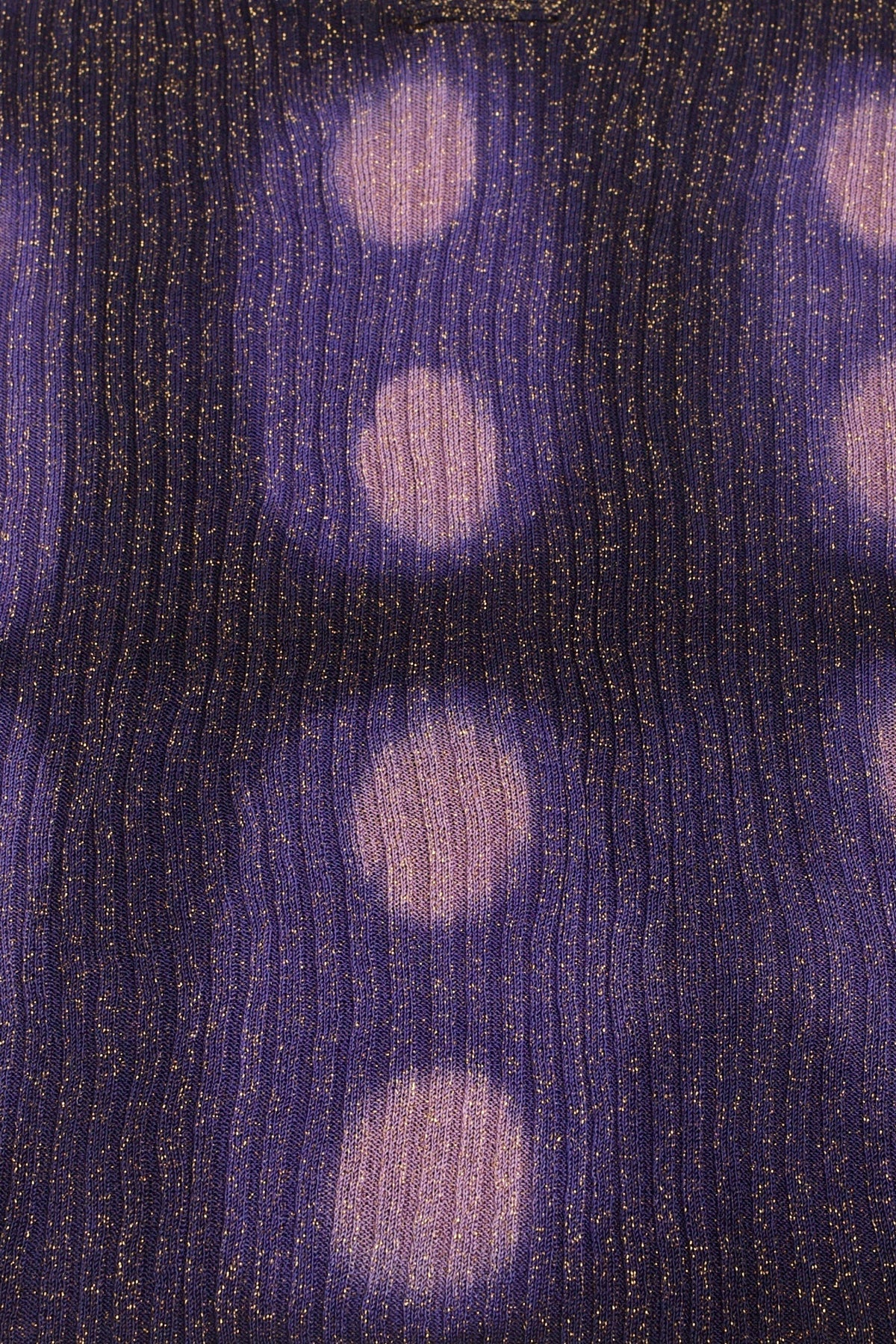 Close-up of the hand tie-dyed lilac circles on the navy ribbed knit