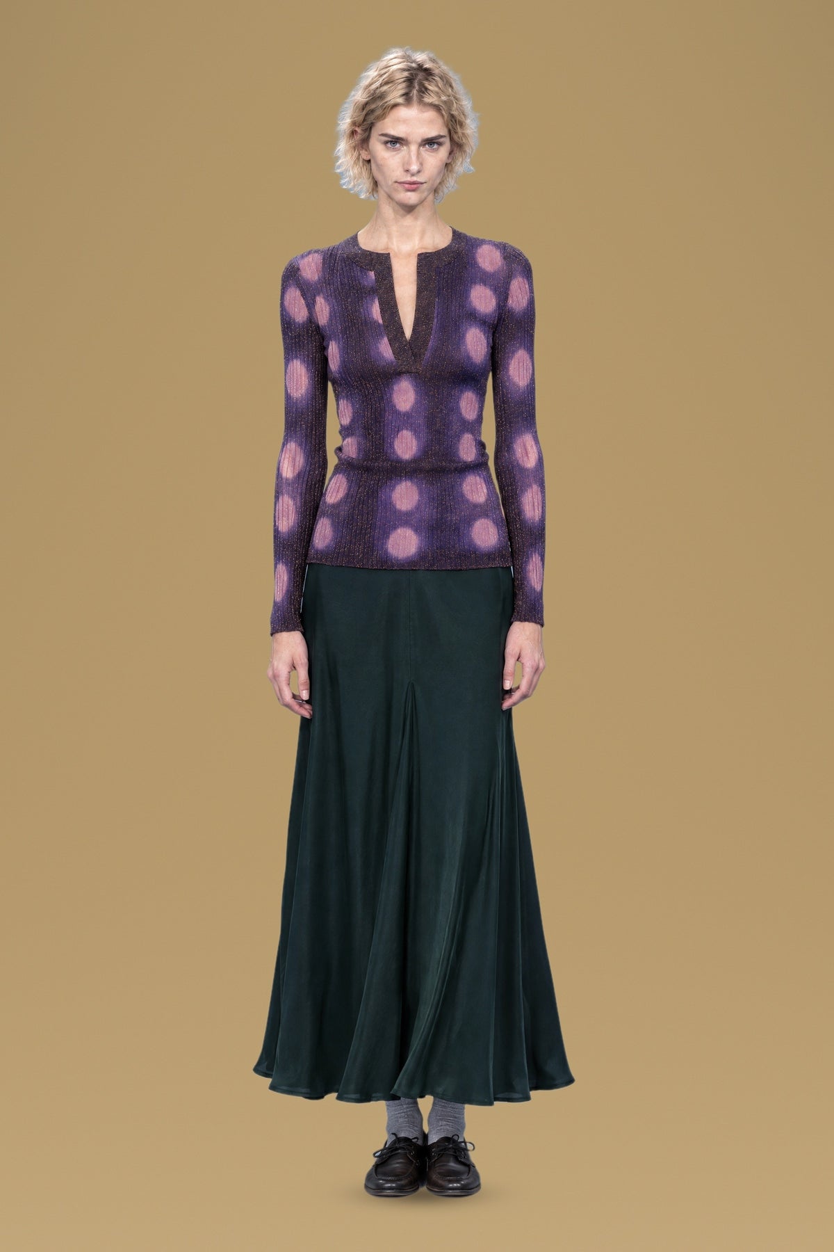 Navy ribbed henley sweater with lilac tie-dye circles, front view, worn with a dark green skirt