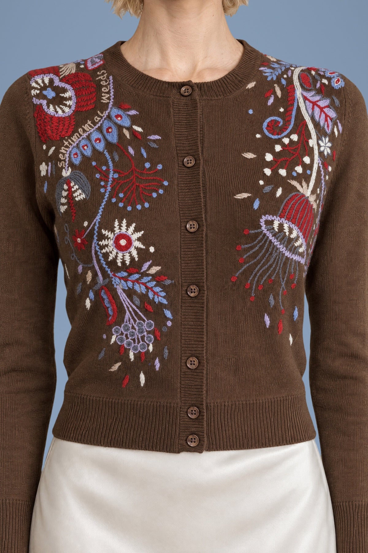 Close-up of the hand embroidery and buttons on the brown Rebecchina cardigan