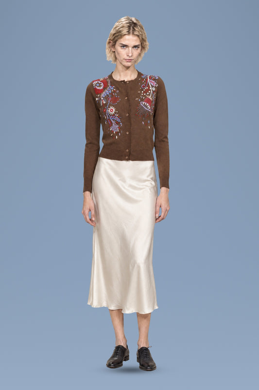 Brown hand-embroidered Rebecchina cardigan, front view, worn with an ivory satin skirt