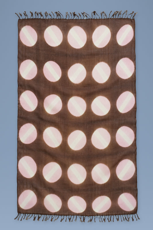 Brown cashmere scarf with hand tie-dyed pink and cream circles, laid open with fringed ends