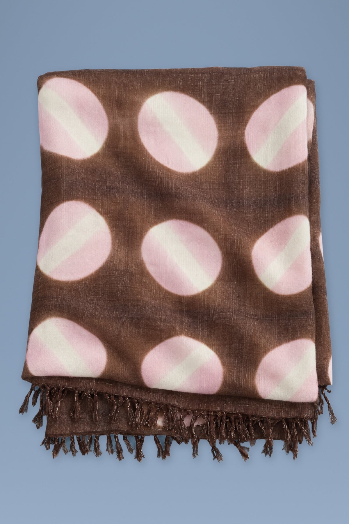 Brown tie-dye circles cashmere scarf folded, fringes at the bottom