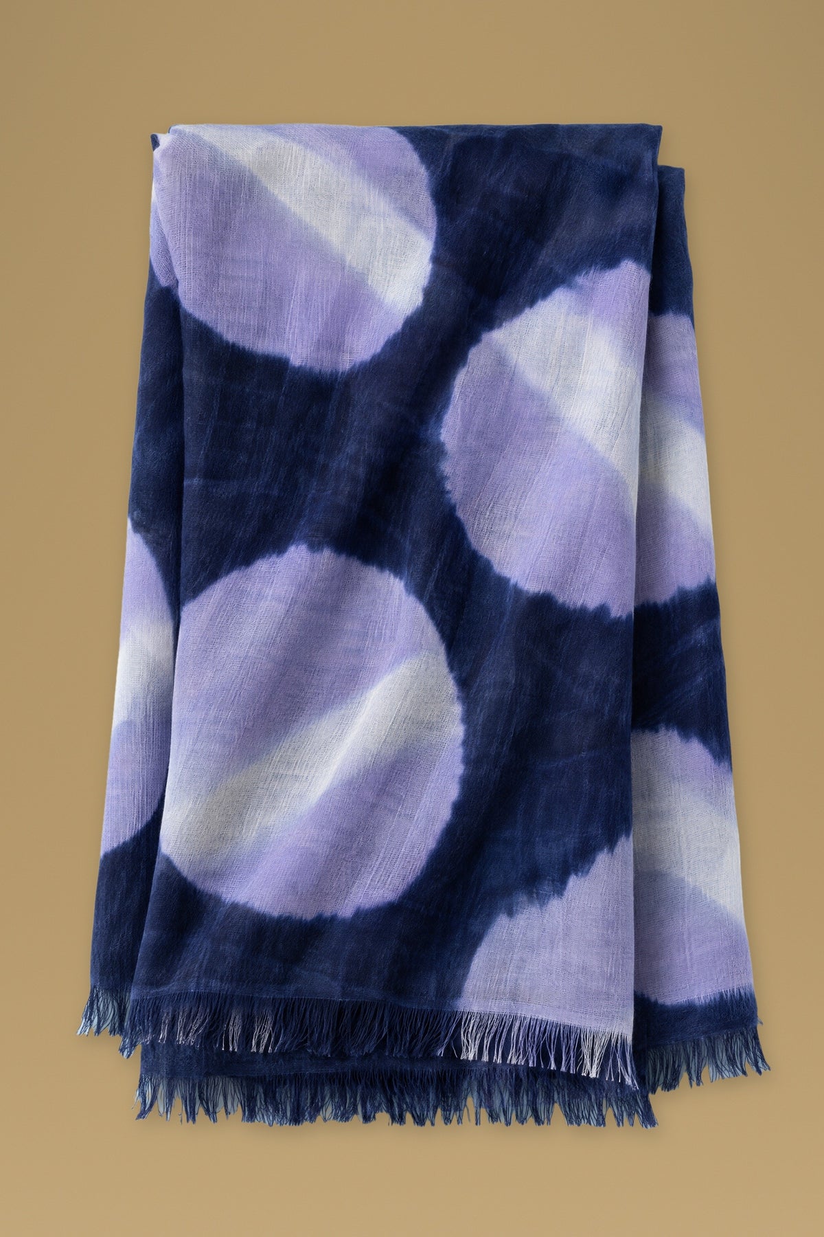 Navy tie-dye circles cashmere scarf folded, fringes at the bottom
