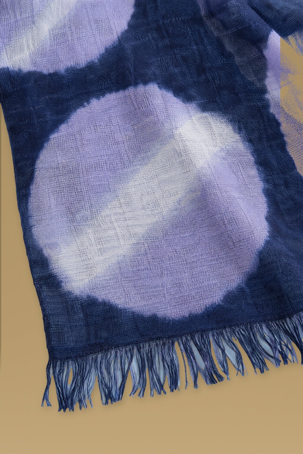 Close-up of the hand tie-dyed lilac circles on the navy cashmere scarf